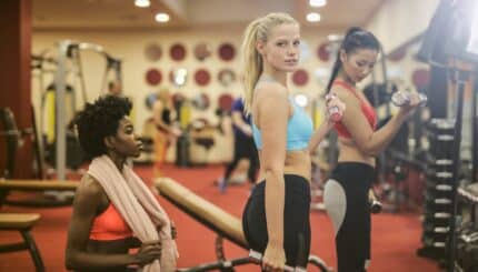 women in sports bra and black leggings while doing exercise