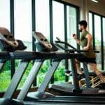 The boy is exercising on the treadmill