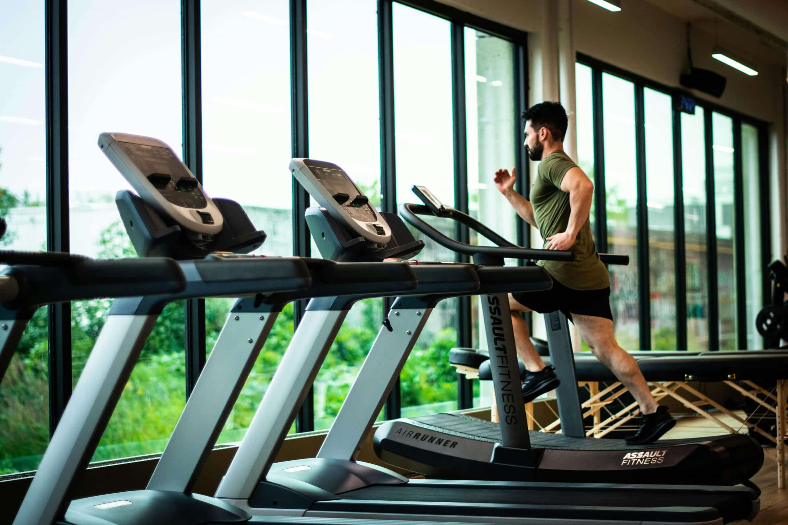 The boy is exercising on the treadmill